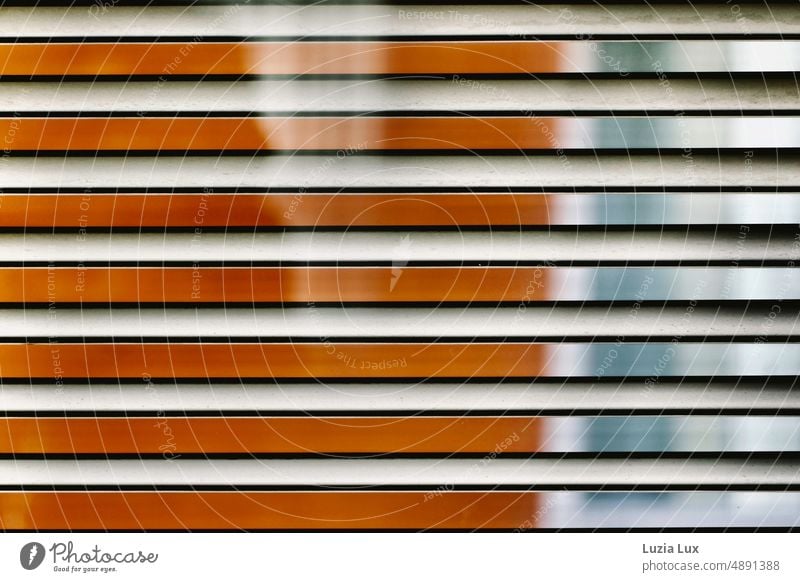 Stripes orange and blue, view through a blind in bright sun on the opposite house and window facade Striped Light sunshine Sunlight Flashy Glistening Summer