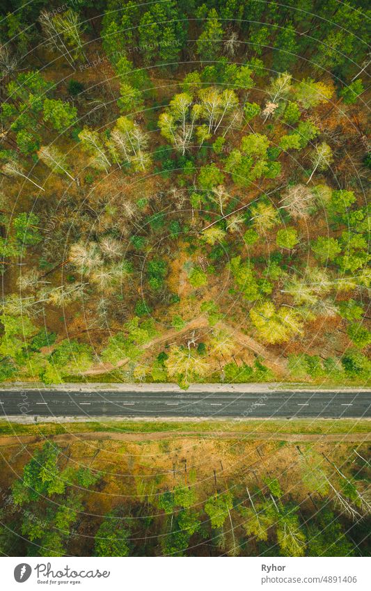 Aerial View Of Road Through Spring Forest Landscape. Top View Of Country Road aerial aerial view attitude beautiful country road elevated view environment