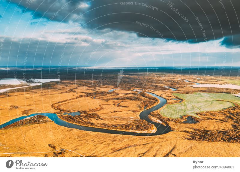 Europe. Aerial View Of Dry Grass And Partly Frozen Curved River Landscape In Autumn Day. High Attitude View. Marsh Bog. Drone View. Bird's Eye View aerial