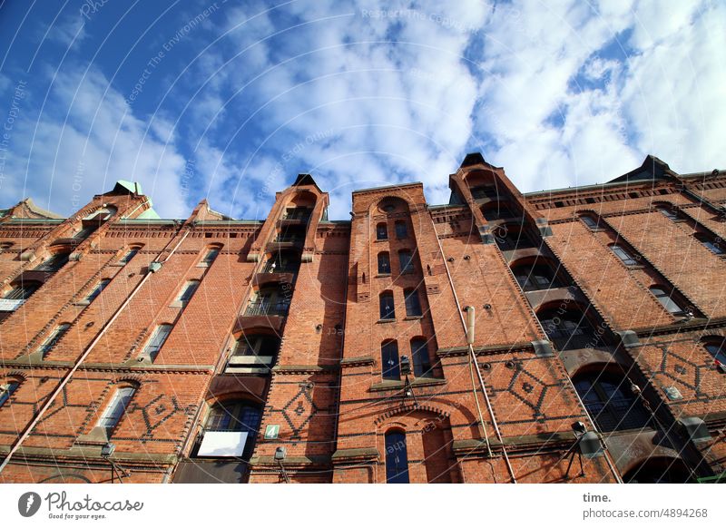 ArtCityTour | meter high Facade Brick storehouse city Window Wall (barrier) Sky Clouds Above Tall sunny Airy Fresh Storehouse Hamburg decoration pediment