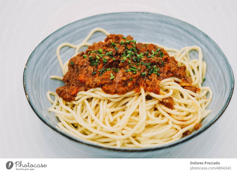 A plate of spaghetti with bolognese sauce ideal for a children's menu appetizing background basil basil leaf cheese classic closeup cooked cooking cuisine