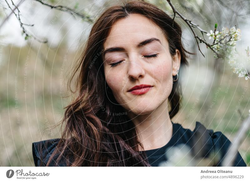 Spring portrait of a young woman Woman Spring flower Young woman millennial Woman`s head Portrait photograph portrait photography spring portrait Serene