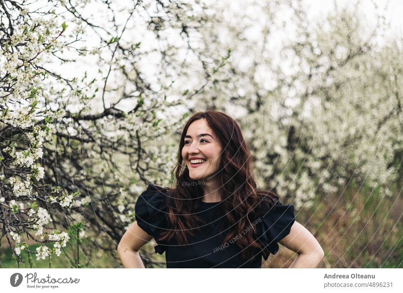 Spring portrait of a young happy woman. Woman Woman`s head Spring flower blossoming flowers millennial Portrait of a woman Black Smiling Smile image