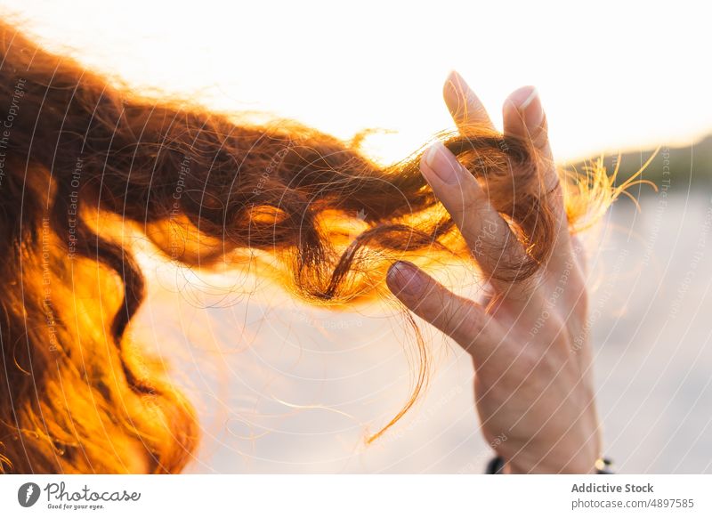 Cropped Hand Of Woman In Curly Hair Redhead Playing Closeup Part Of Finger Sunlight Lifestyle Tousled Leisure Positive Holiday Outdoors Day One Person Adult