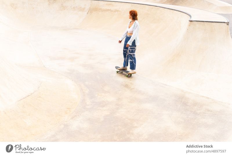 Woman riding skateboard in skate park woman ride skateboarder hobby training sport ramp pastime move energy sporty motion dynamic action skill practice active