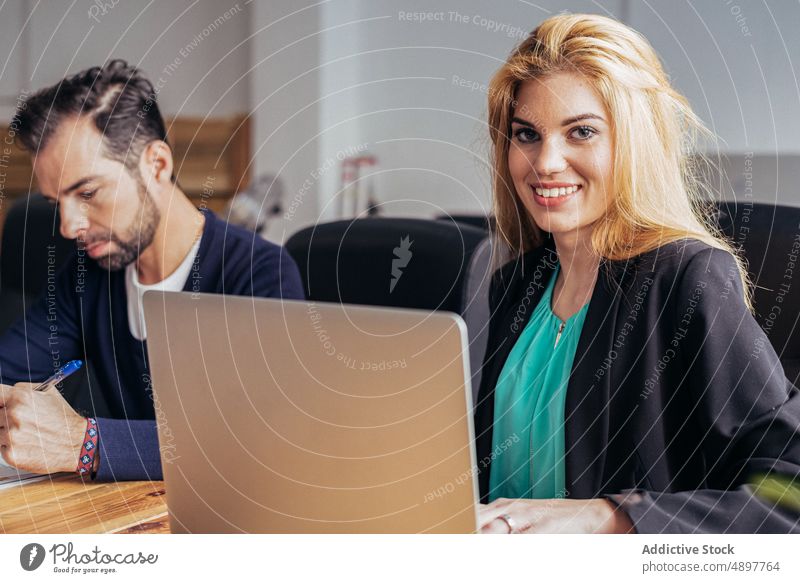 Joyful woman working with document and computer typing browsing office workplace project business businesswoman using formal positive female surfing career