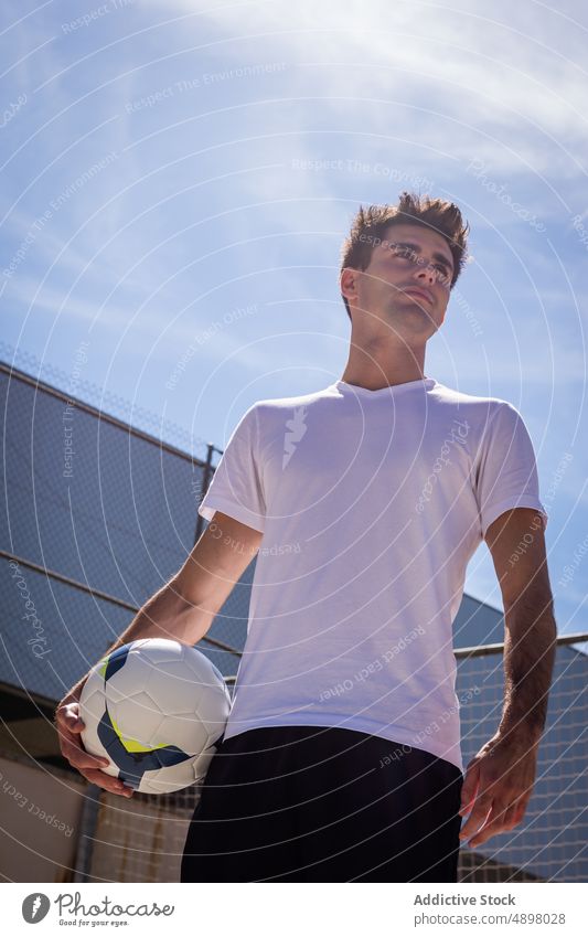 Young Football Player Looking Away Male Serious Soccer Ball Practicing Athlete Playing Sport Fitness Hobby Court Goal Competition net Handsome Sportsman Active
