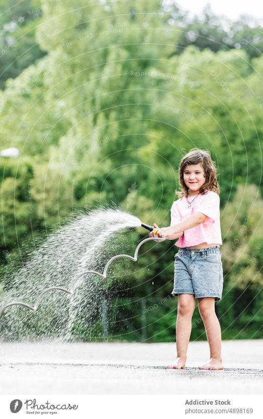 Smiling Girl In Casual Clothes Spraying With Hose Car Car Wash Motion Clean Water Cute Wet Smile Happy Care Lifestyle Little Playing Fun Innocent Outside