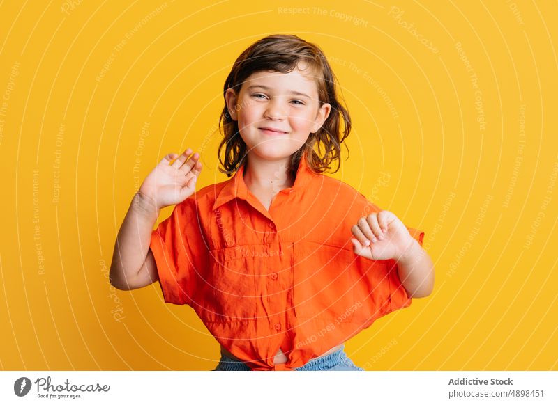 Cheerful girl smiling on colorful background smile happy style bright child casual portrait delight gesture childhood little glad vibrant joy sincere vivid kid