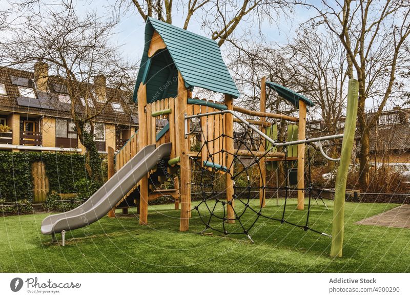 Playground at the back of a house backyard exterior outside playground green slide property home grass kids land fenced area architecture children sky wood
