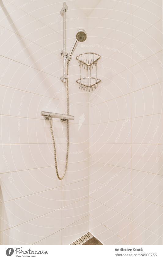 Shower detail with white walls shower tile bathroom design architecture hygiene indoor luxury faucet home bright clean house water cabinet contemporary elegance