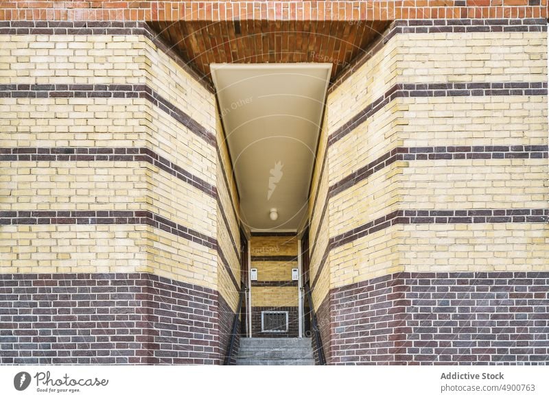 Entrance to a brick building door entrance exterior architecture front nobody old wall structure doorway home urban house outdoors facade apartment community