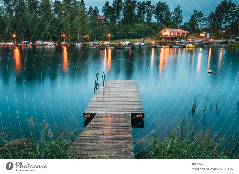 Sweden. Beautiful Wooden Pier Near Lake In Summer Evening Night. Lake Or River Landscape Swedish apartment beautiful beauty in nature boat building cabin calm