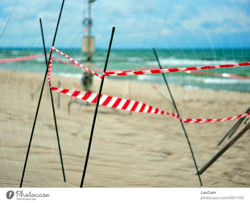 Beach walk with obstacles cordon Walk on the beach barrier tape flutterband Ocean coast Reddish white Bans Safety Barrier Structures and shapes