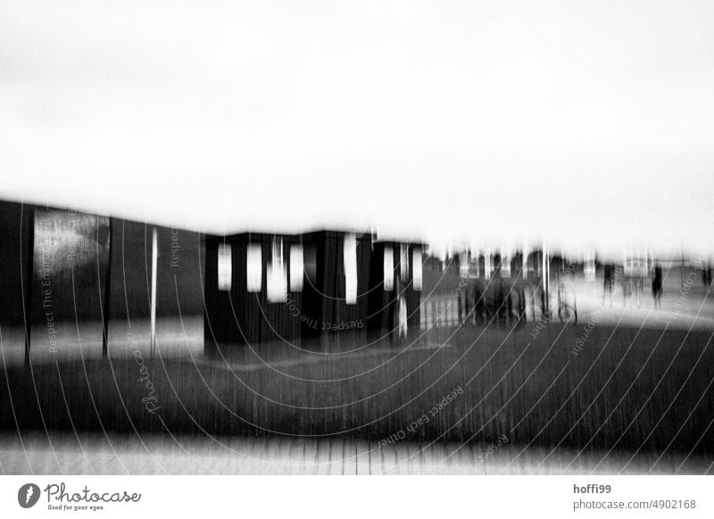 blurred beach houses / cabins with bicycles and people in front of a dike ICM ICM technology Beach hut Row vibrating abstract photography Abstract hazy overlay