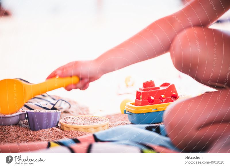 Child playing with the sand on bathing beach Summer children Playing Joy Infancy fun Happy vacation Vacation & Travel Nature toys Beach Ocean sea Water