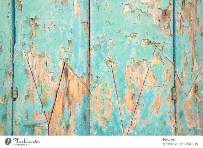 Wooden facade with peeling paint worn colorful parquet gate door turquoise green blue line grunge antique tree vertical blank structure abstract decoration