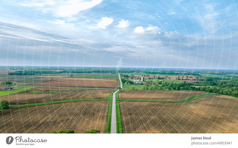 Rural country Road heads to the horizon in rural wisconsin spring american nature land meadow background agriculture summer drone road tree growth photography