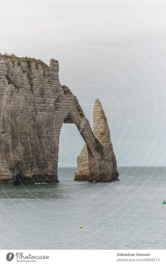 The cliff of Falaise d'Aval on a summer day in Etretat, Normandy, France rock landscape arch landmark sea tourism etretat grass coast water travel blue normandy