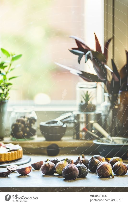 Figs on kitchen table with  baking utensils at window background figs preparing mediterranean fruit front view blurred cake cooking food fresh home