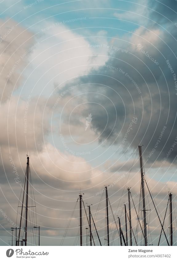 Sailboat masts on sky background sailboat sailboats abstract yacht Yacht harbour Harbour Serene ocassion Ocean coastal travel sailing Boating trip boating