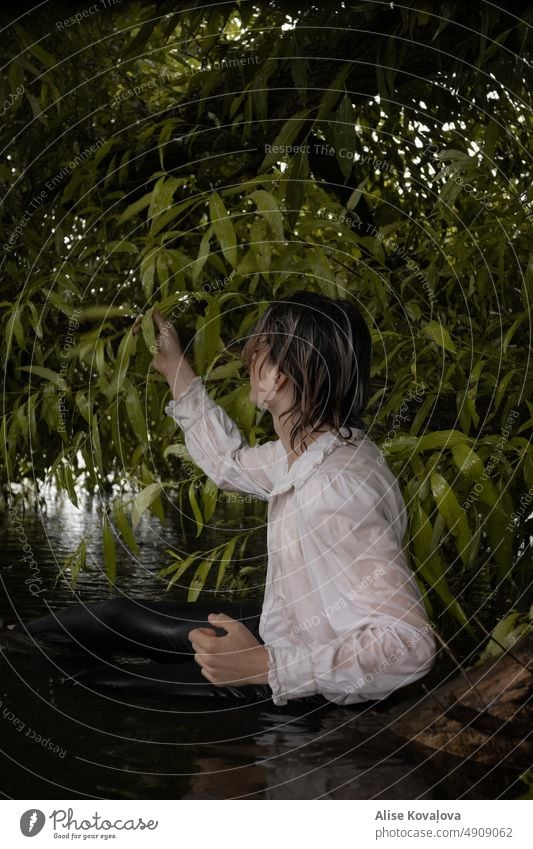wet white blouse portraits man water river wet clothes River Colour photo touching leaves sitting on a branch by the river River bank Nature sitting in a river
