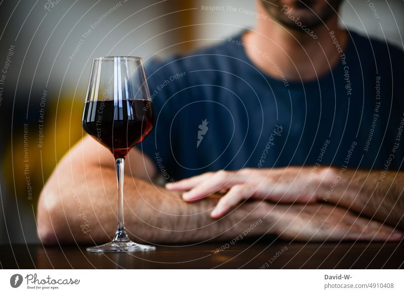 Man sitting at table with glass of red wine Red wine Alcoholic drinks alcohol consumption Table Vine Self Control Beverage Elegant alcoholism Anonymous