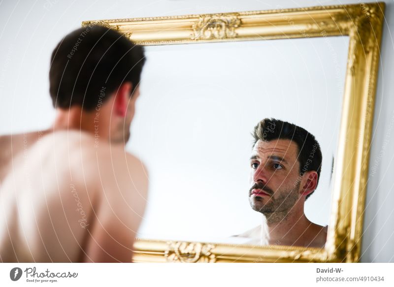 A man's listless look in the mirror Man Looking Mirror frustrated depressive depression Mirror image sad Emotions desperate dissatisfied Meditative thoughts