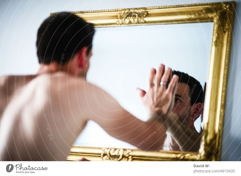 Man looks at himself in mirror Mirror look at Insecure Dissatisfaction Body Naked Mirror image Looking depression psyche Anorexia self-reflection