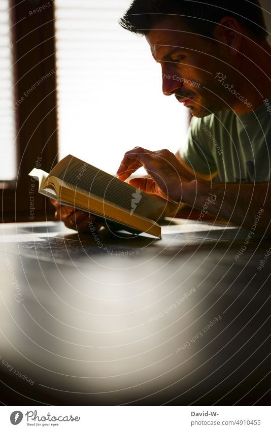 read - man with book in hand Book Reading Man Face hollowed Study Novel Education Literature Know concentrated Table Sunlight Shadow Light School