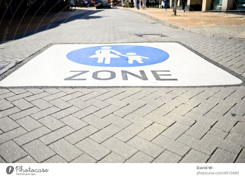 Marking - pedestrian zone with large road marking Pedestrian precinct Road marking mother and child sign Street Signs and labeling Lanes & trails