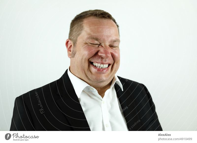 Portrait of man in suit laughing with closed eyes. Man Suit Business Masculine Colour photo Shirt Human being 1 Elegant Success portrait Joy Laughter wittily