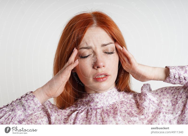 woman suffering from headache or migraine massaging her temples to relieve the pain massage stress relief closed eyes eyes closed businesswoman girl female
