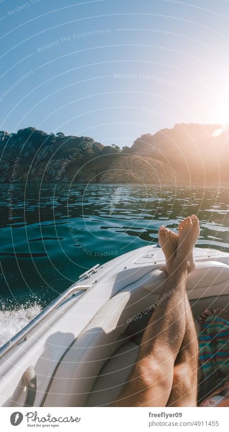 First person view of a man relaxing on a boat vacation POV legs luxury islands cies vigo enjoying sun people comfortable sleep carefree foot selfie freedom