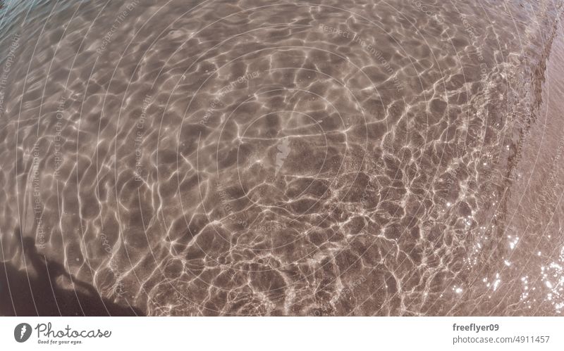 Ripples on the water against sand ripples beach light effect copy space waves texture clean marin holiday nature vacation tranquil swim background bright