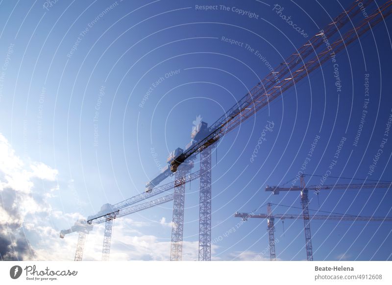 Construction cranes symbolize economic boom and progress Construction site Crane Sky Industry Build Work and employment Technology Workplace Tall Exterior shot