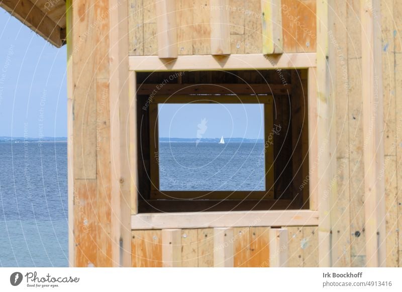 View through old wooden hut into window frame with sailing ship and sea Window Looking Ocean Sailing ship Wooden hut unusual Frame framed