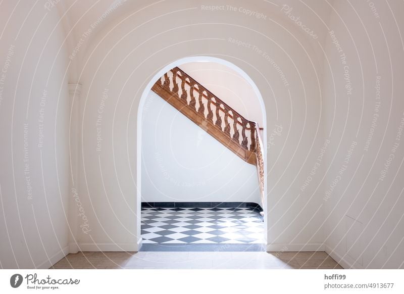 elegant, wooden, richly decorated staircase behind an archway Stairs wooden staircase Staircase Ornate Minimalistic minimalism Museum Architecture Wood Shadow