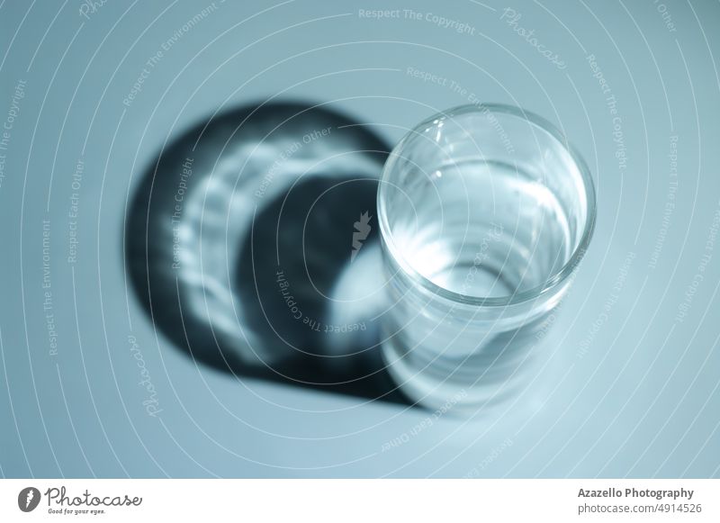 Glass of water with shadow. Minimal still life image of water. aqua beverage blue body clean clean water clear cold water concept conceptual creative diet