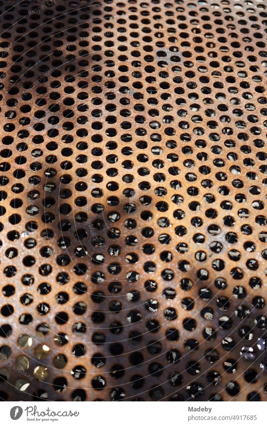 Rusty perforated sheet with shade in sunshine at the pier in Konak district in Izmir bay in summer on the Aegean Sea in Turkey Asia Minor Anatolia oriental