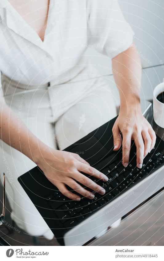 Close up image of a woman working at home office remotely, working and typing on the keyboard, hands close up.Freelancer Woman Chatting Over the Internet on Social Networks