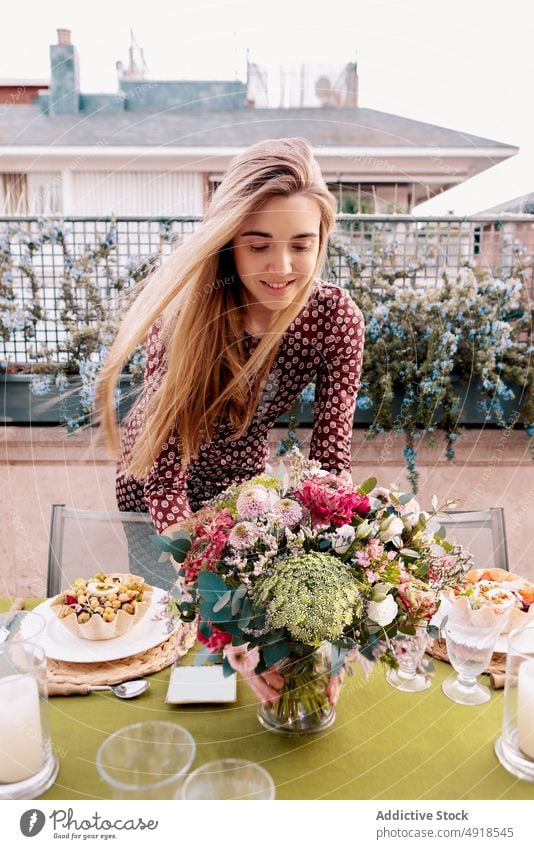 Woman arranging table together on terrace woman arrange food flower appetizer banquet spend time spare time tasty plant floral bouquet starter delicious