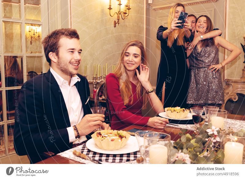 Friends having dinner in restaurant couple friend cheers glass group alcohol celebrate occasion reunion meeting meal red wine selfie self portrait food banquet