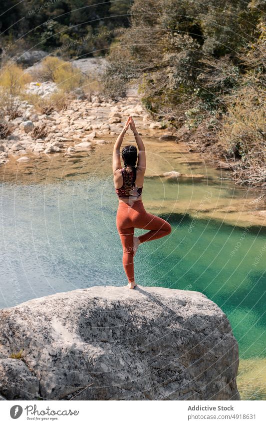Woman practicing yoga in the river nature woman lifestyle Utthita Trikonasana female lake healthy adult relaxation summer young exercise body beauty sport