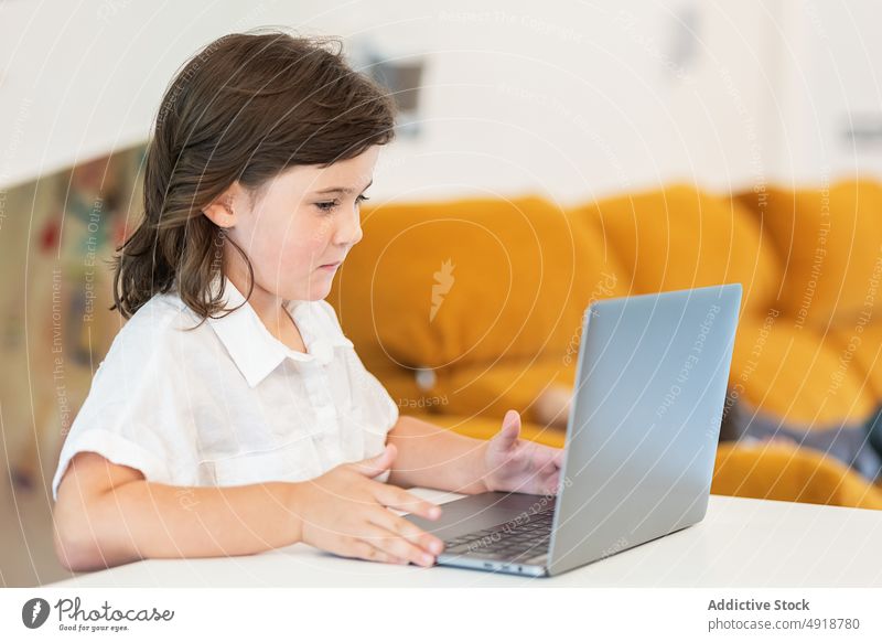 Girl sitting in front of a laptop girl young home computer student education headphones learning focus beautiful browsing studying online internet person