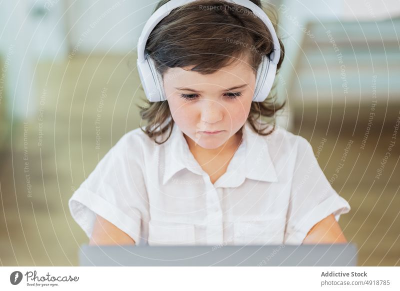 Girl sitting in front of a laptop girl young home computer student education headphones learning focus beautiful browsing studying online internet person