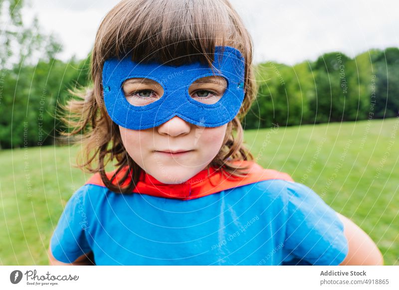 Little girl with superhero mask park play weekend costume serious summer incognito protect kid child imagination fearless brave strong inspiration fantasy
