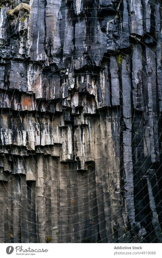 Basalt formation with natural columns in Iceland cliff basalt nature geology texture rocky abstract background surface rough massive mineral solid stone iceland