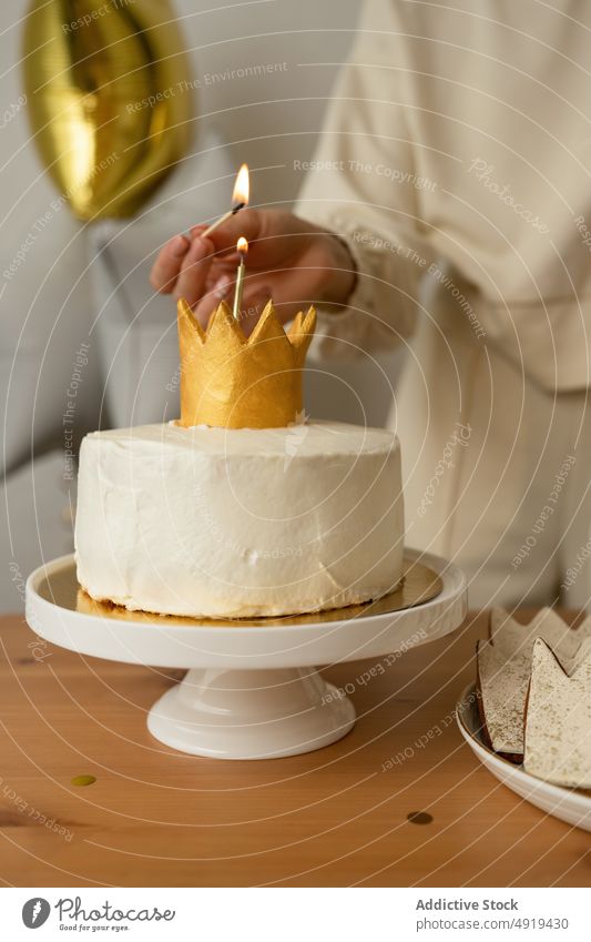 Unrecognizable woman lighting a candle from a cupcake anonymous sweet girl cream food delicious dessert faceless crop person background bakery people holding