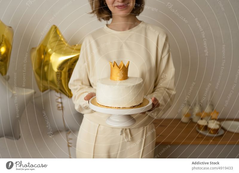 Unrecognizable woman holding a cupcake anonymous sweet girl cream food delicious dessert faceless crop person background bakery people celebration unhealthy